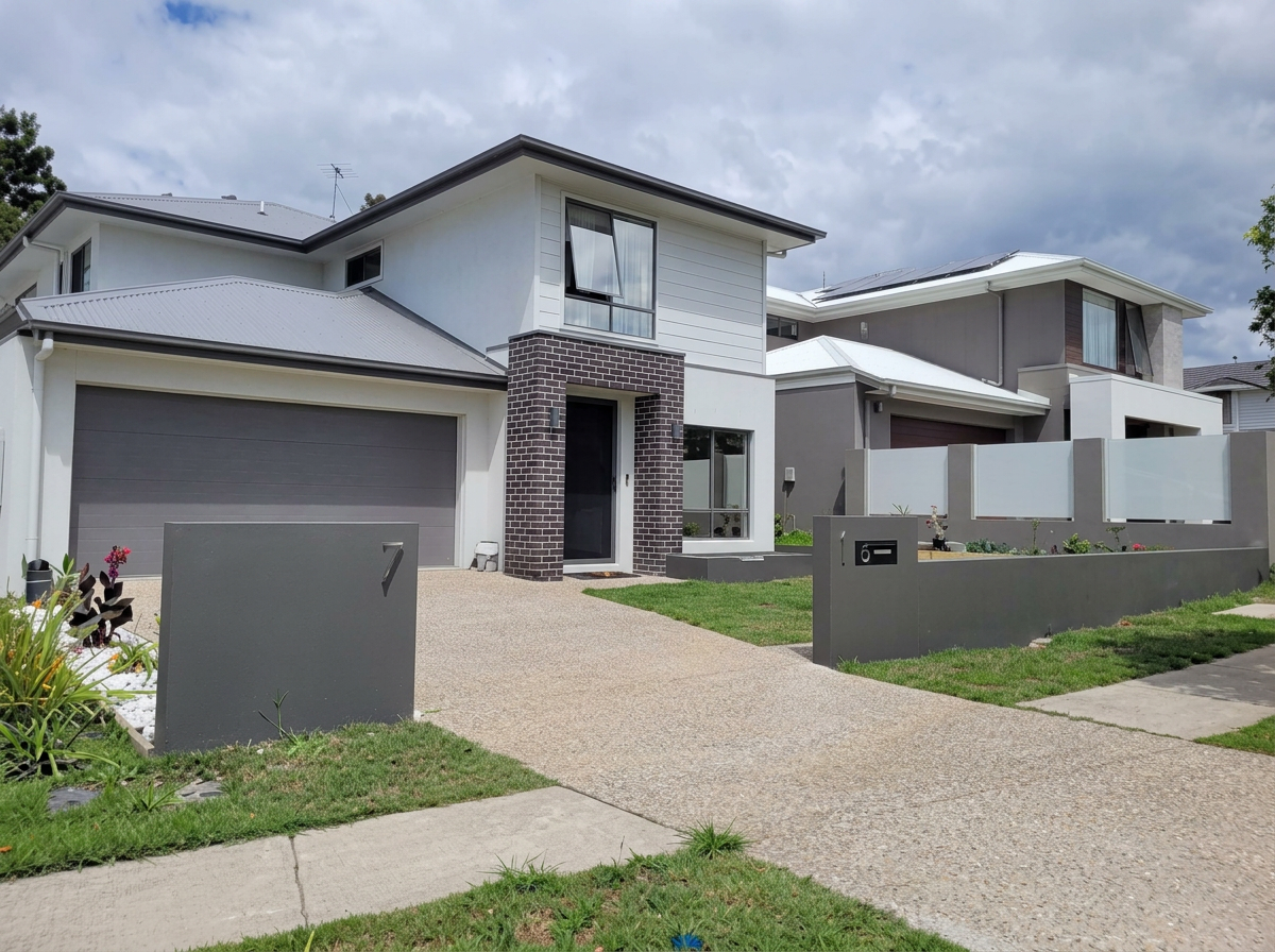 Modern duplex with mixed render and timber-look feature